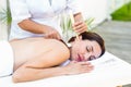 Relaxed brunette getting an ear candling treatment Royalty Free Stock Photo