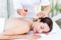 Relaxed brunette getting an ear candling treatment Royalty Free Stock Photo