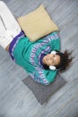 Relaxed brunette girl listening to music lying on the floor of her house Royalty Free Stock Photo