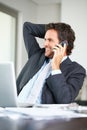Relaxed business man on phone. Relaxed business man having a friendly conversation on mobile phone. Royalty Free Stock Photo