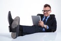 Relaxed business man reads on tablet