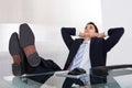 Relaxed businessman daydreaming in office