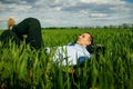 Relaxed Businessman Lying On Grass At Park Royalty Free Stock Photo