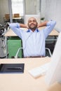 Relaxed businessman listening music at desk Royalty Free Stock Photo