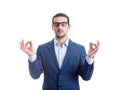 Relaxed businessman meditating as keeps eyes closed holds fingers in zen gesture, isolate on white background. Business spiritual