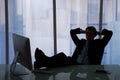 Relaxed Businessman Sitting At Computer Desk In Office Royalty Free Stock Photo