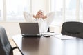 Relaxed Businessman Sitting At Desk In Office Royalty Free Stock Photo