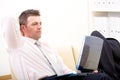 Relaxed businessman using laptop