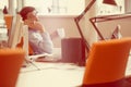 Relaxed businessman at workplace at early morning, relaxing, at startup office. Royalty Free Stock Photo