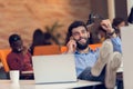 Relaxed businessman at workplace at early morning, relaxing, at startup office. Royalty Free Stock Photo