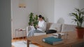 Relaxed businesswoman working home sofa. Lady studying laptop checking cellphone