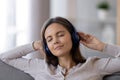 Relaxed calm teen girl wearing headphones listening to soothing music Royalty Free Stock Photo