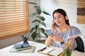 Relaxed and calm young Asian woman using her phone and listening to music Royalty Free Stock Photo