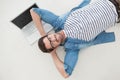 Relaxed casual businessman lying on his laptop Royalty Free Stock Photo