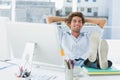 Relaxed casual man with legs on desk in bright office Royalty Free Stock Photo