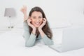 Relaxed casual smiling woman with laptop in bed Royalty Free Stock Photo