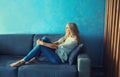 Relaxed caucasian middle-aged woman in eyeglasses resting in the room sitting on the couch at home Royalty Free Stock Photo