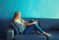 Relaxed caucasian middle-aged woman in eyeglasses resting in the room sitting on the couch at home Royalty Free Stock Photo