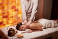 Relaxed caucasian smiling woman receiving back massage in spa Royalty Free Stock Photo