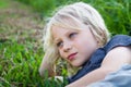 Relaxed child outdoors lying on grass