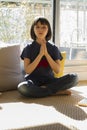 Relaxed child practicing a yoga namaste for happiness and wellbeing