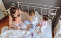 Relaxed children having breakfast over the bed