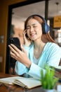 Relaxed chilling young asian female eyes closed while listening to music