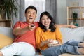 Relaxed chinese family watching TV together at home Royalty Free Stock Photo
