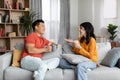 Relaxed chinese lovers enjoying conversation, drinking coffee Royalty Free Stock Photo