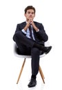 Relaxed contemplation. A pensive young businessman sitting on his chair. Royalty Free Stock Photo