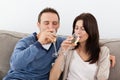 Relaxed couple drinking champagne on the sofa Royalty Free Stock Photo