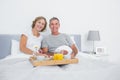 Relaxed couple having breakfast in bed together Royalty Free Stock Photo
