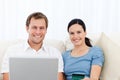 Relaxed couple with laptop and credit card