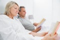 Relaxed couple reading books in bed Royalty Free Stock Photo
