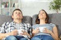 Relaxed couple resting at home on a couch Royalty Free Stock Photo