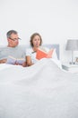 Relaxed couple sitting in bed reading books Royalty Free Stock Photo