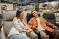 Relaxed couple sitting at comfortable armchair enjoying shopping time Royalty Free Stock Photo