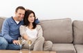 Relaxed couple watching television