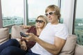 Relaxed couple wearing 3D glasses and watching TV at home Royalty Free Stock Photo