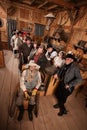 Relaxed Crowd with Guns in Saloon Royalty Free Stock Photo