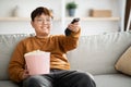 Relaxed chinese kid watching TV at home Royalty Free Stock Photo