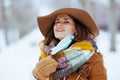 Relaxed elegant woman outside in city park in winter