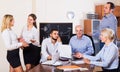 Relaxed employees sitting at desk