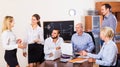 Relaxed employees sitting at desk