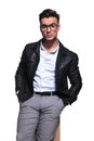 Relaxed fashion man wearing leather jacket and sunglasses sitting Royalty Free Stock Photo