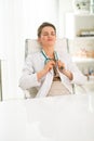 Relaxed female doctor sitting at a desk in the office