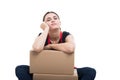 Relaxed female seller standing on cardboard boxes Royalty Free Stock Photo