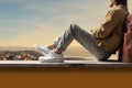 Relaxed figure on a ledge, legs crossed, enjoying a scenic moment