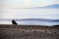 Relaxed fisherman fishing on the beach