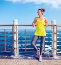 Relaxed fitness woman looking into distance at embankment Royalty Free Stock Photo